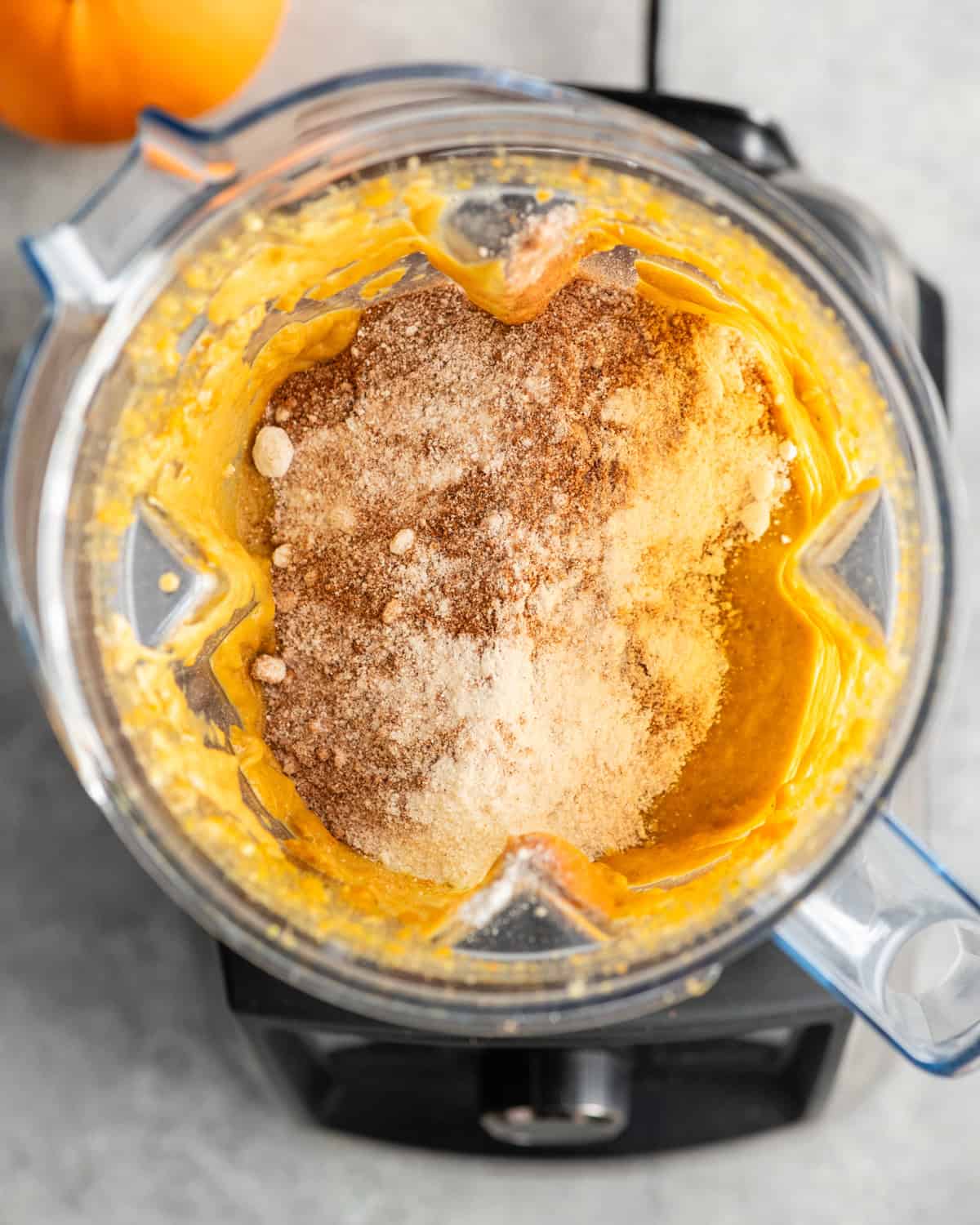 overhead photo of Paleo Pumpkin Zucchini Muffins ingredients in a blender before blending