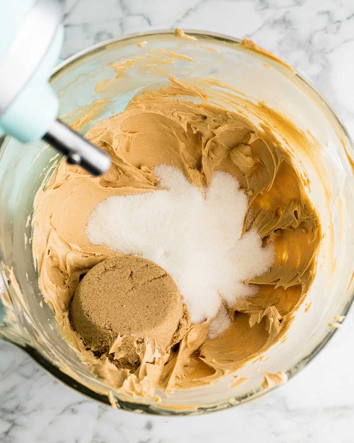 making Peanut Butter Blossoms recipe in a standing mixer - adding sugars to butter/peanut butter mixture