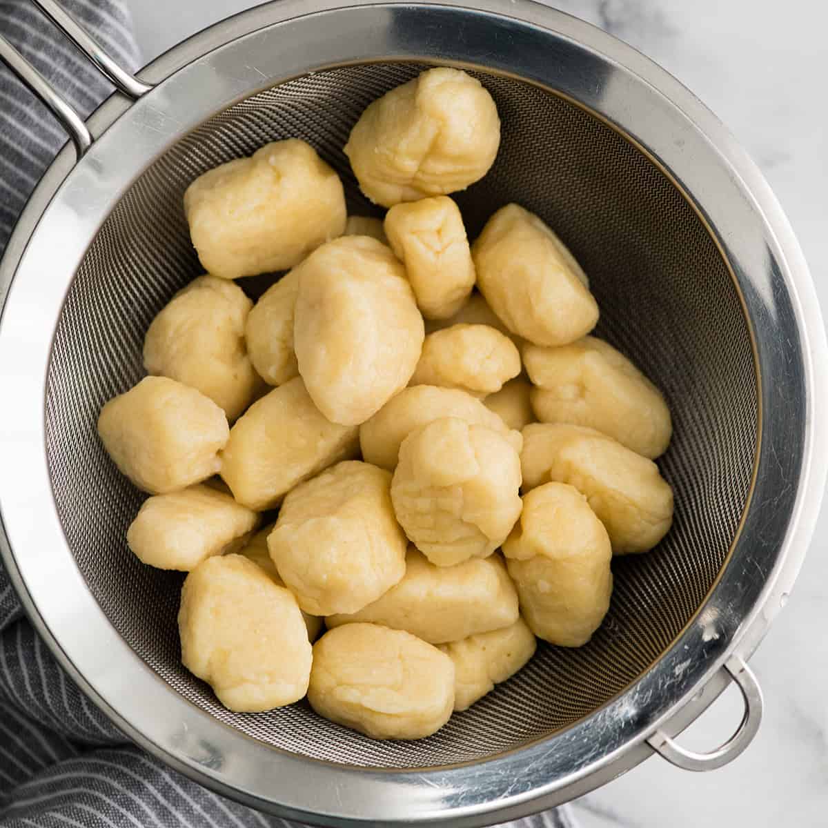 gnocchi after boiling draining in a colander