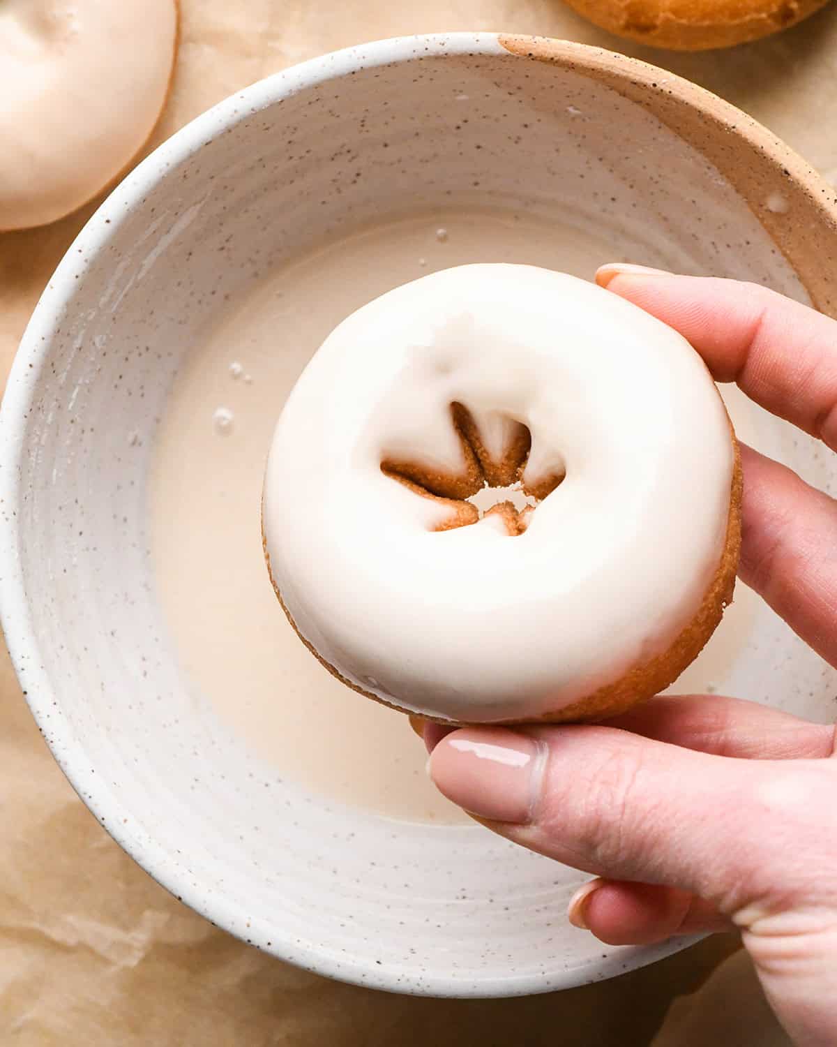 a donut after being dipped into Vanilla Icing