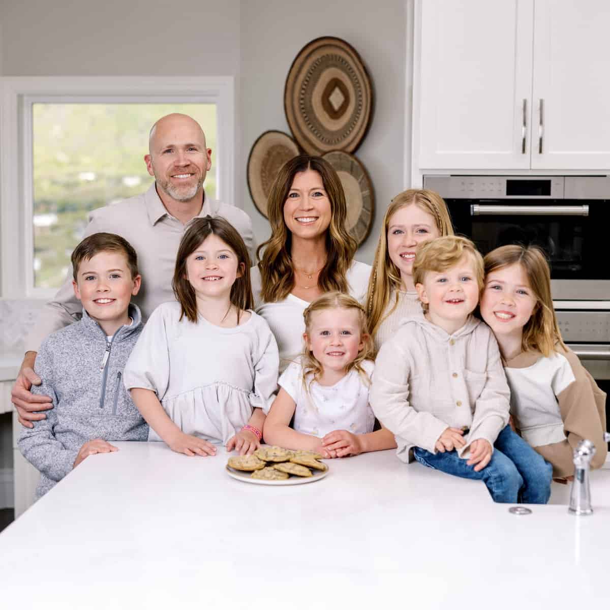 a family of 8 people in a kitchen