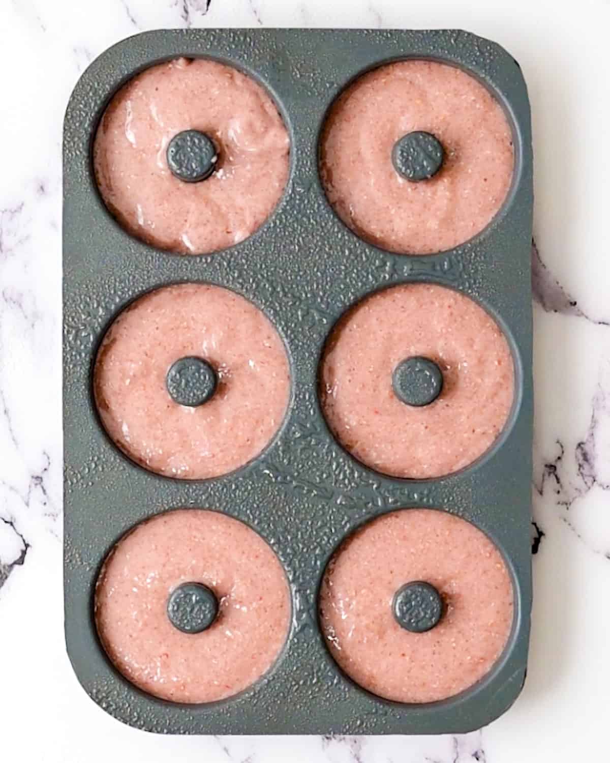 Baked Raspberry Donuts in a donut pan before baking
