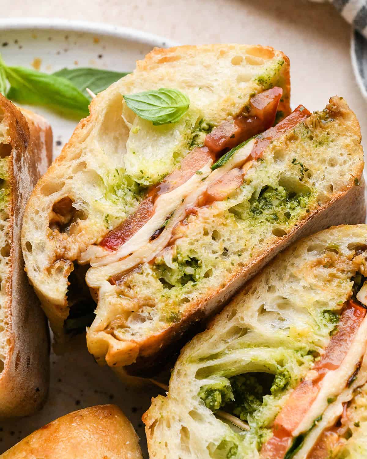 a caprese sandwich on it's side on a plate