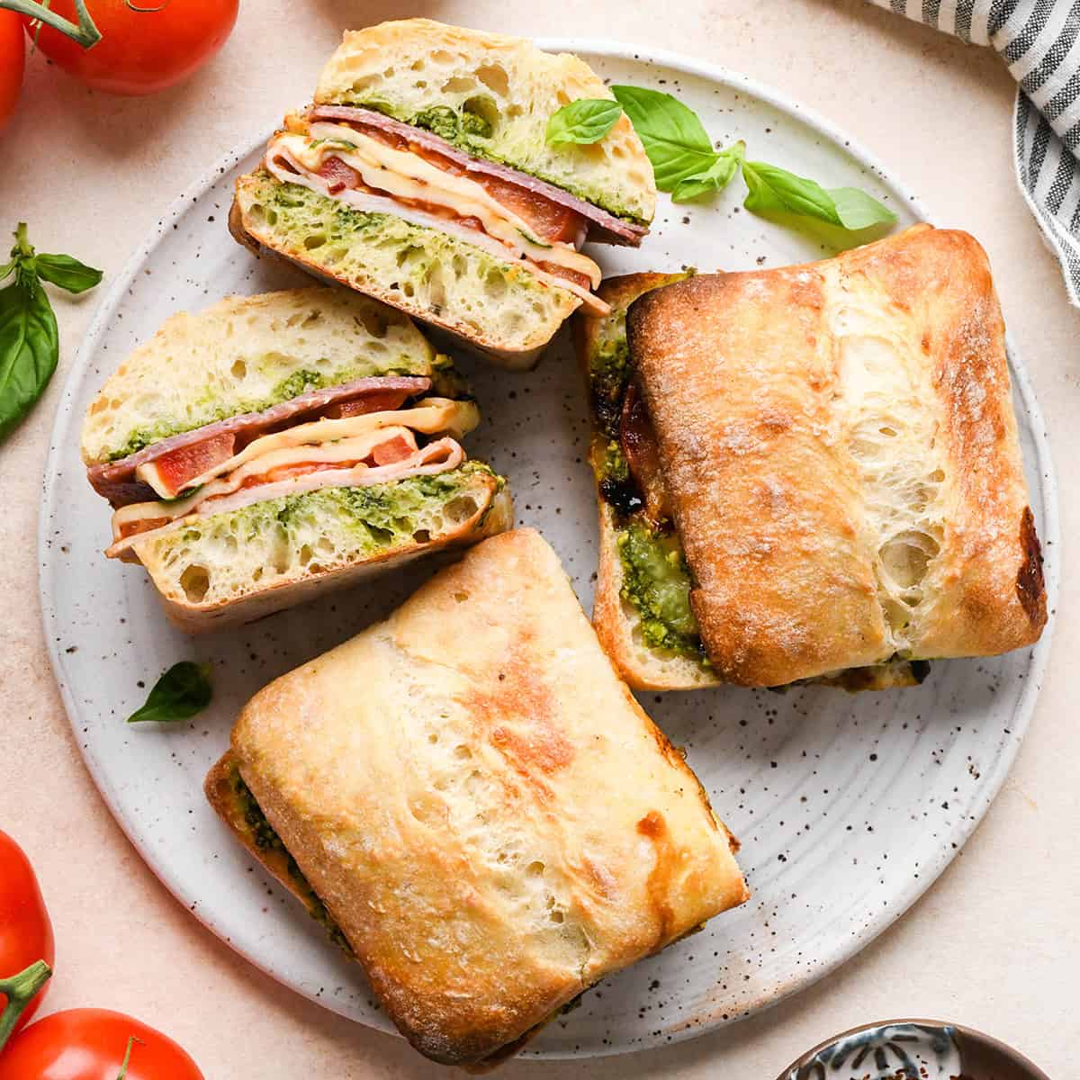 3 Caprese Sandwiches on a plate, one cut in half