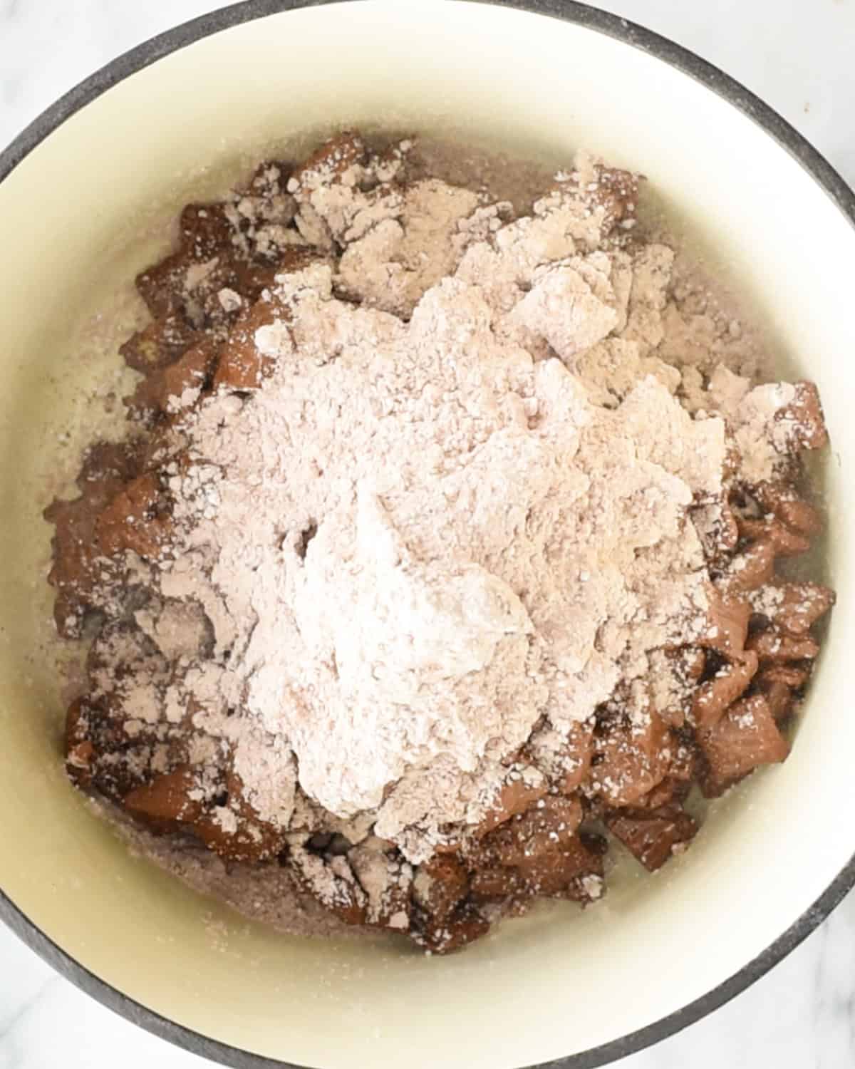 how to make dark chocolate puppy chow - adding powdered sugar & cocoa powder to slightly chilled chocolate coated cereal
