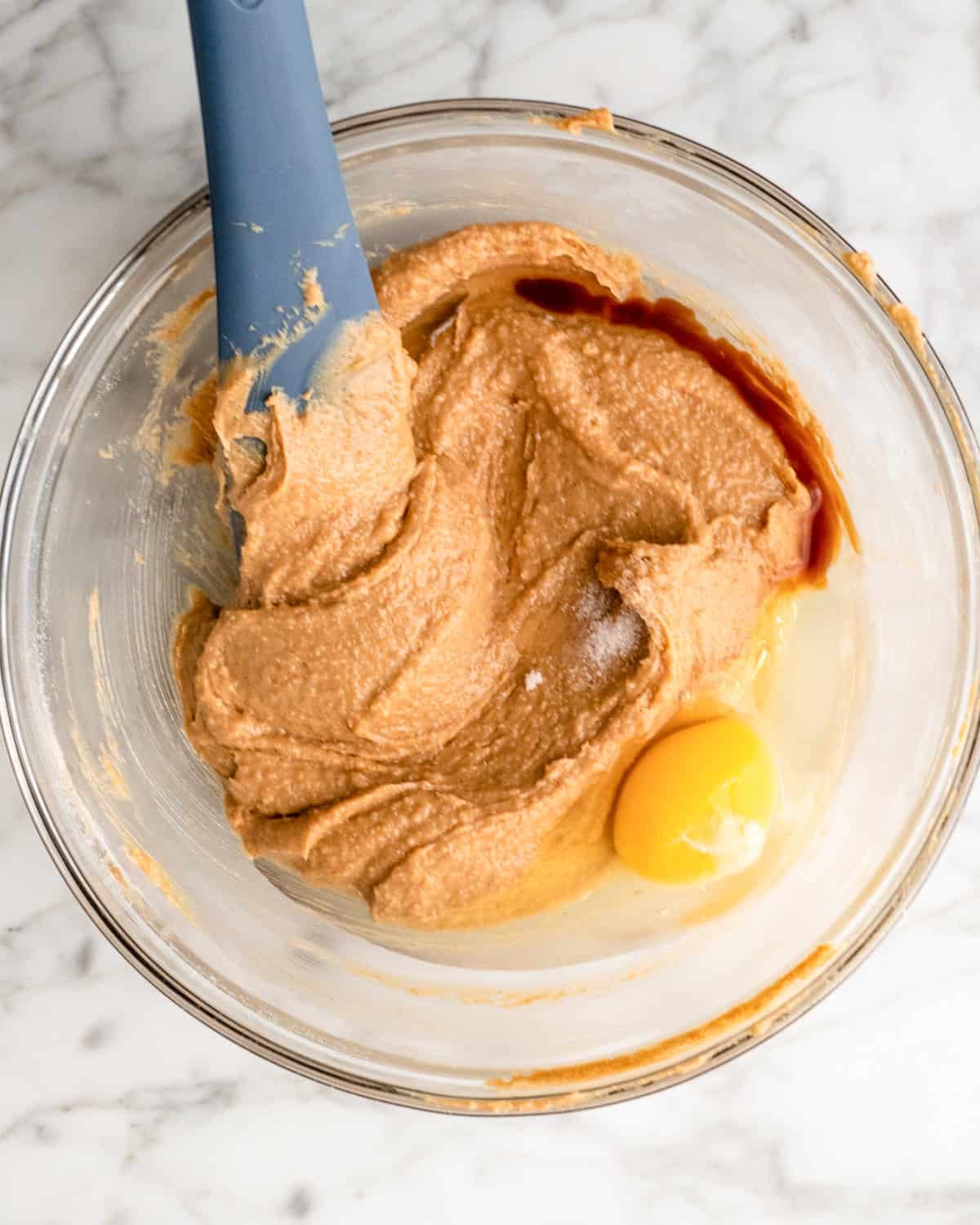 making Gluten Free Peanut Butter Blossoms - adding egg, vanilla and salt
