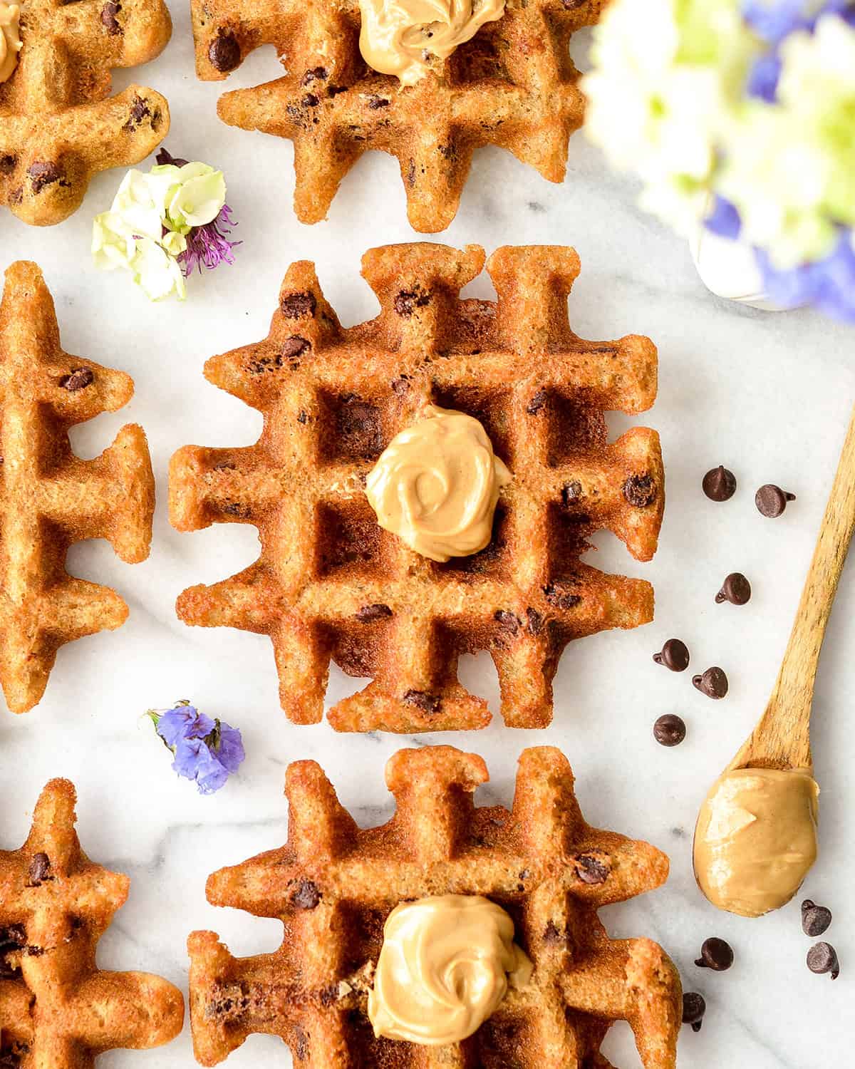 5 Gluten Free Peanut Butter Waffles with peanut butter on top 