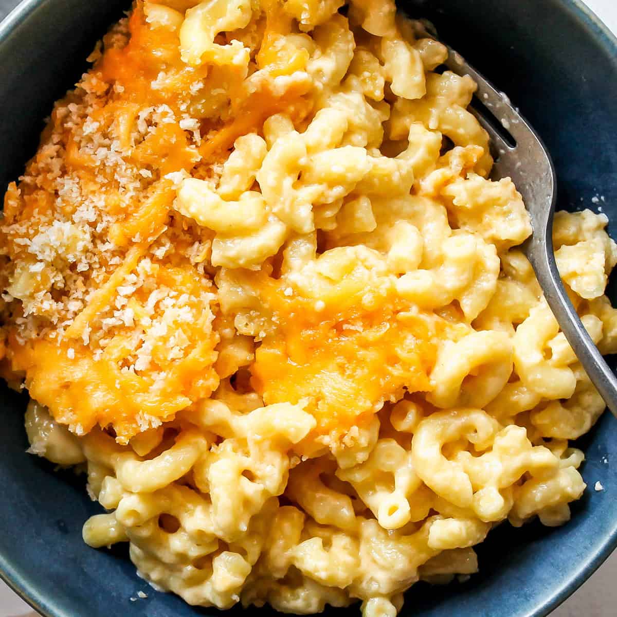 up close photo of Greek Yogurt Mac & Cheese in a bowl with a fork