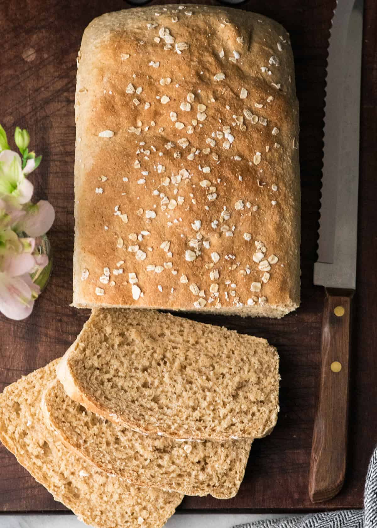 overhead view of a loaf of Honey Wheat Bread with 3 slices cut out of it