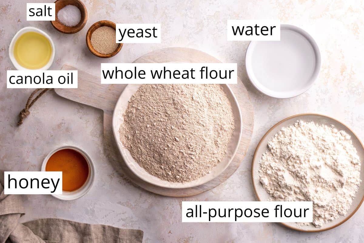 overhead photo of the labeled ingredients in this Honey Wheat Bread recipe