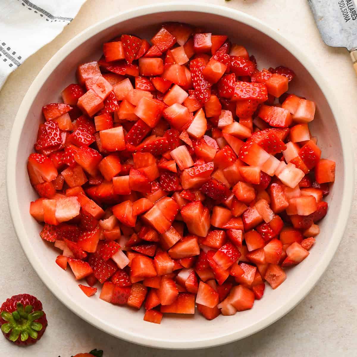 how to make a yogurt parfait - chopped strawberries in a bowl