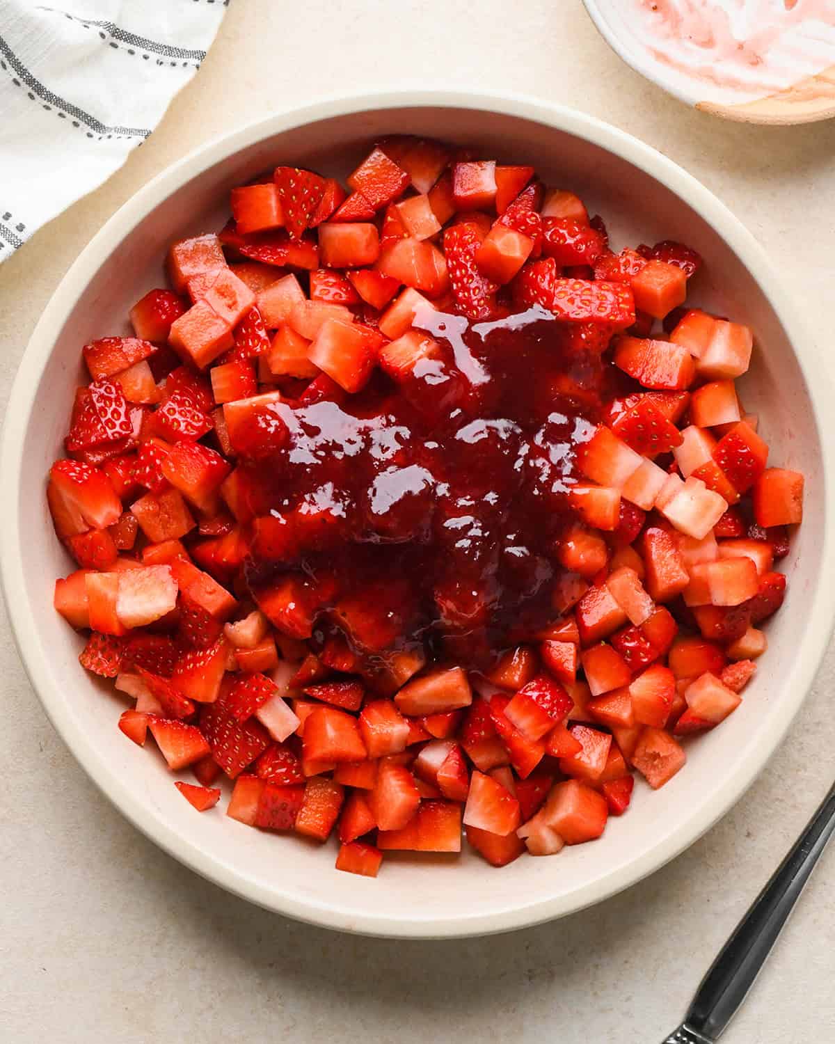 How to Make a Yogurt Parfait - jam added to strawberries before mixing