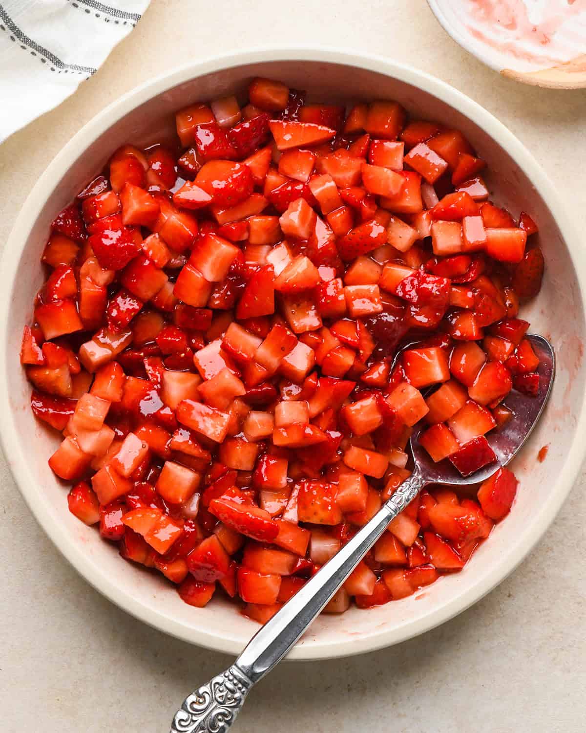 How to Make a Yogurt Parfait - jam and strawberry mixture in a bowl with a spoon