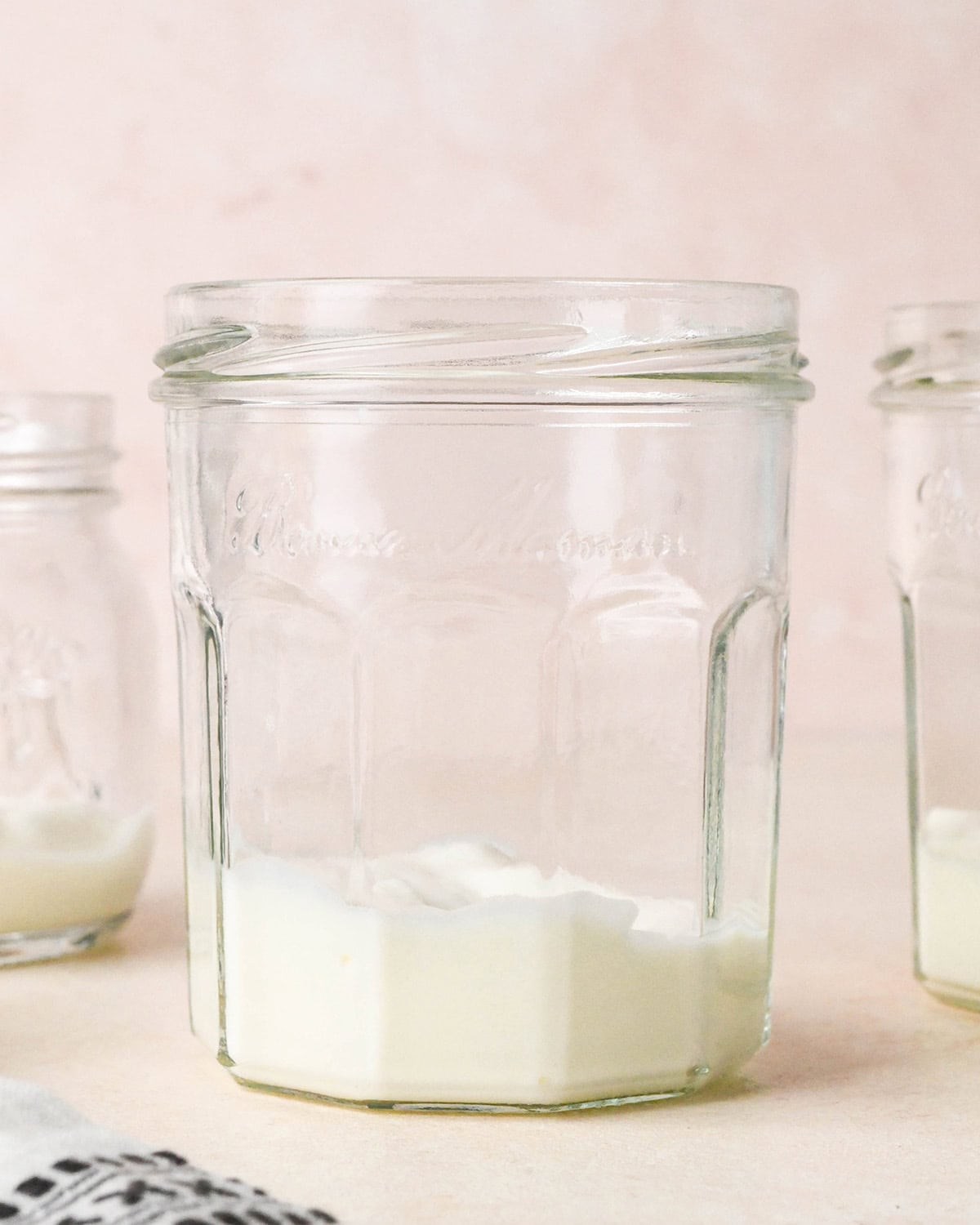 How to Make a Yogurt Parfait - one layer of vanilla yogurt in a glass jar