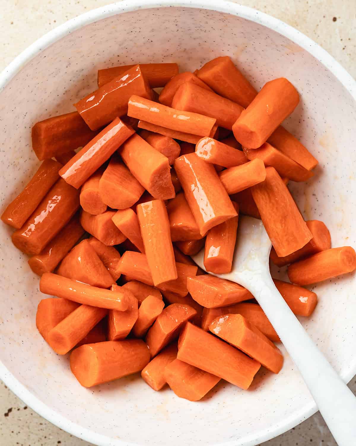 How to Make Baby Food Carrots  - carrots coated in olive oil in a bowl