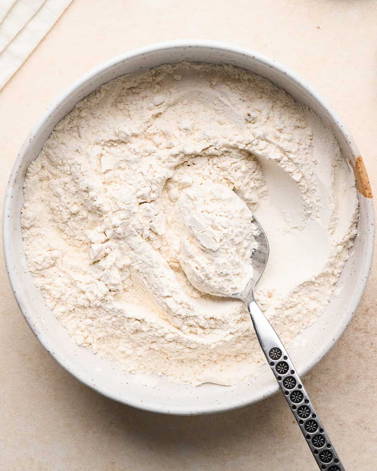 How to Make Blueberry Pancakes - dry ingredients in a bowl with a spoon
