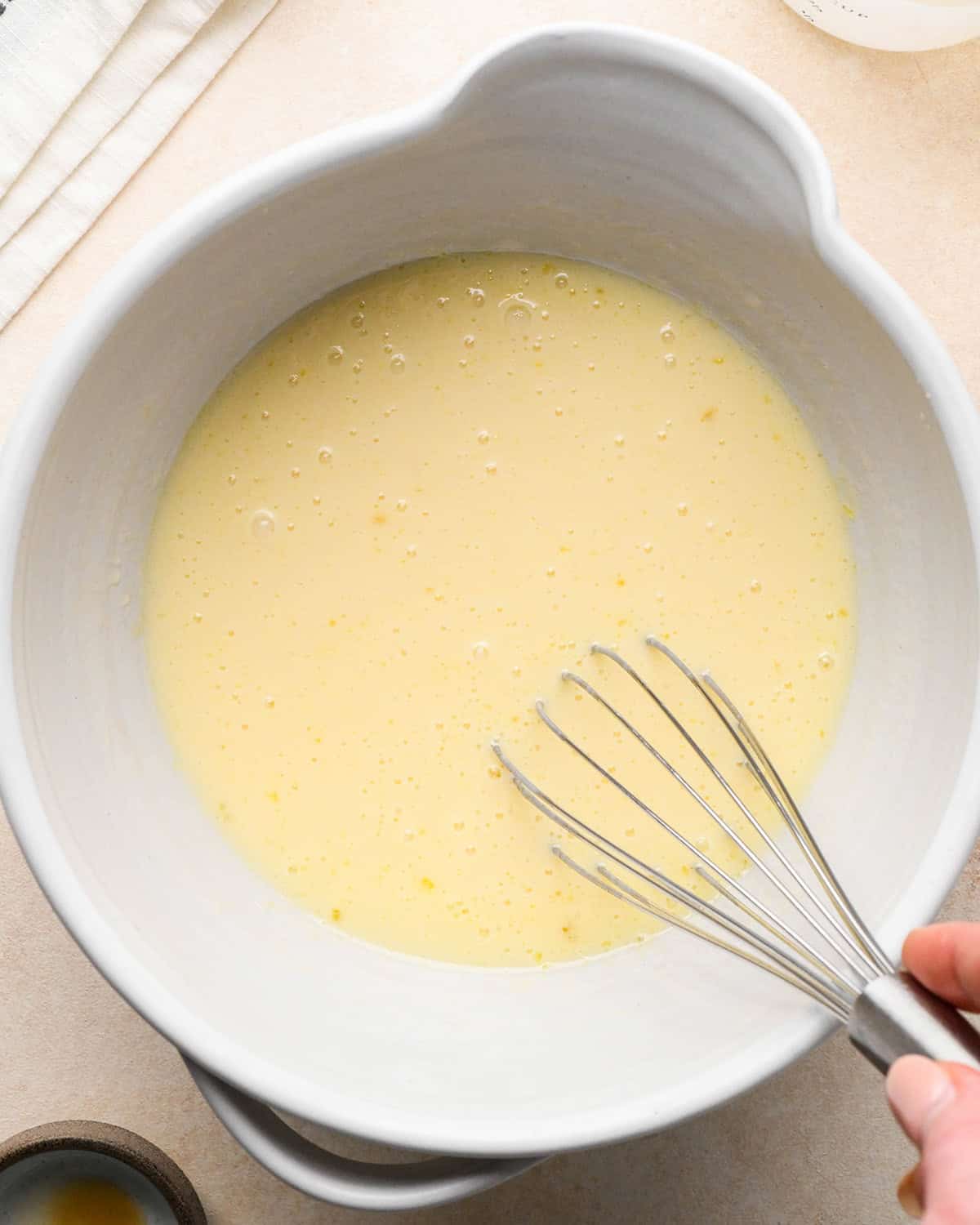 How to Make Blueberry Pancakes wet ingredients whisked in a bowl