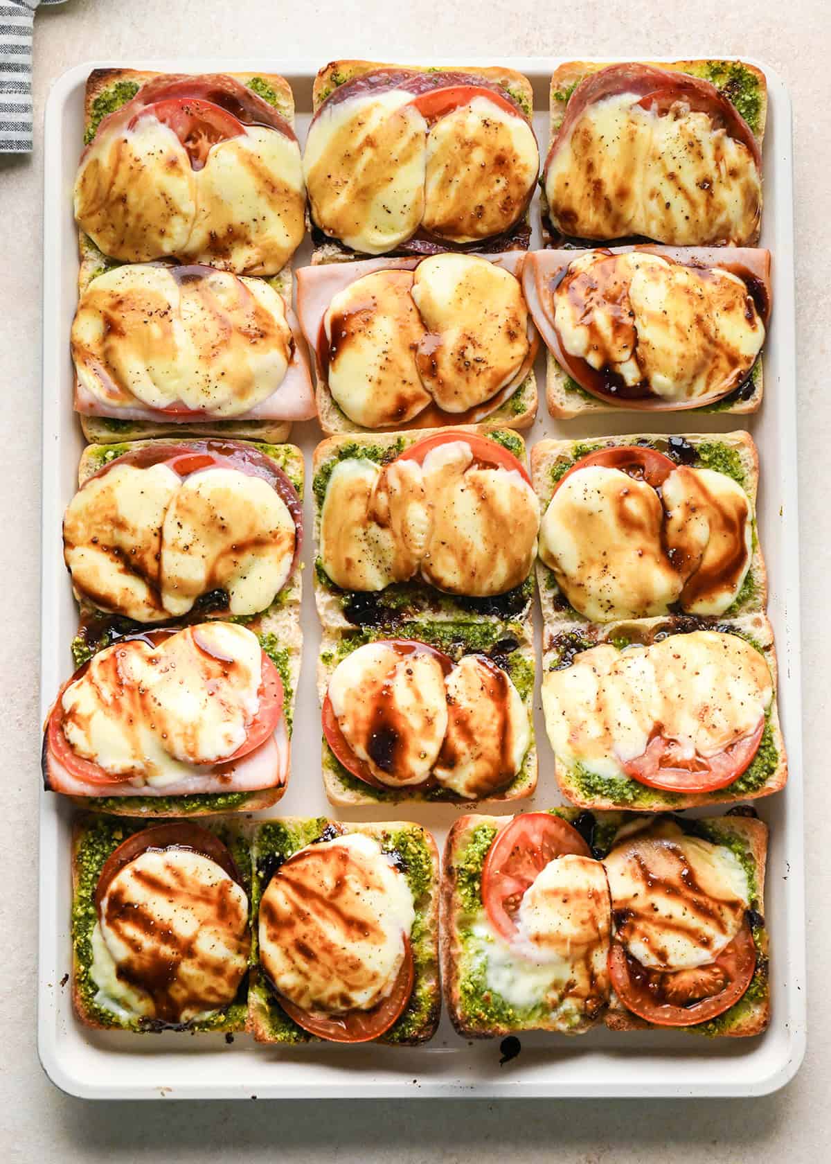 8 Caprese Sandwiches on a baking sheet after baking