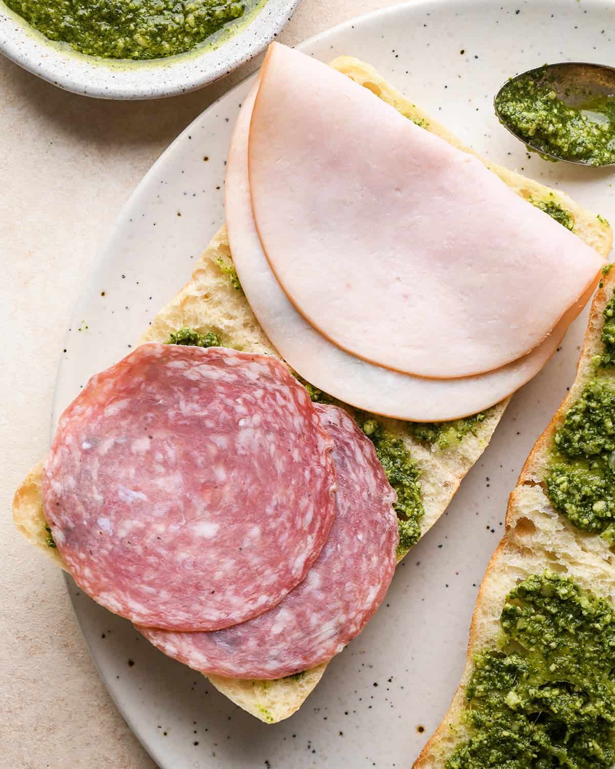 assembling a Caprese Sandwich - adding meat