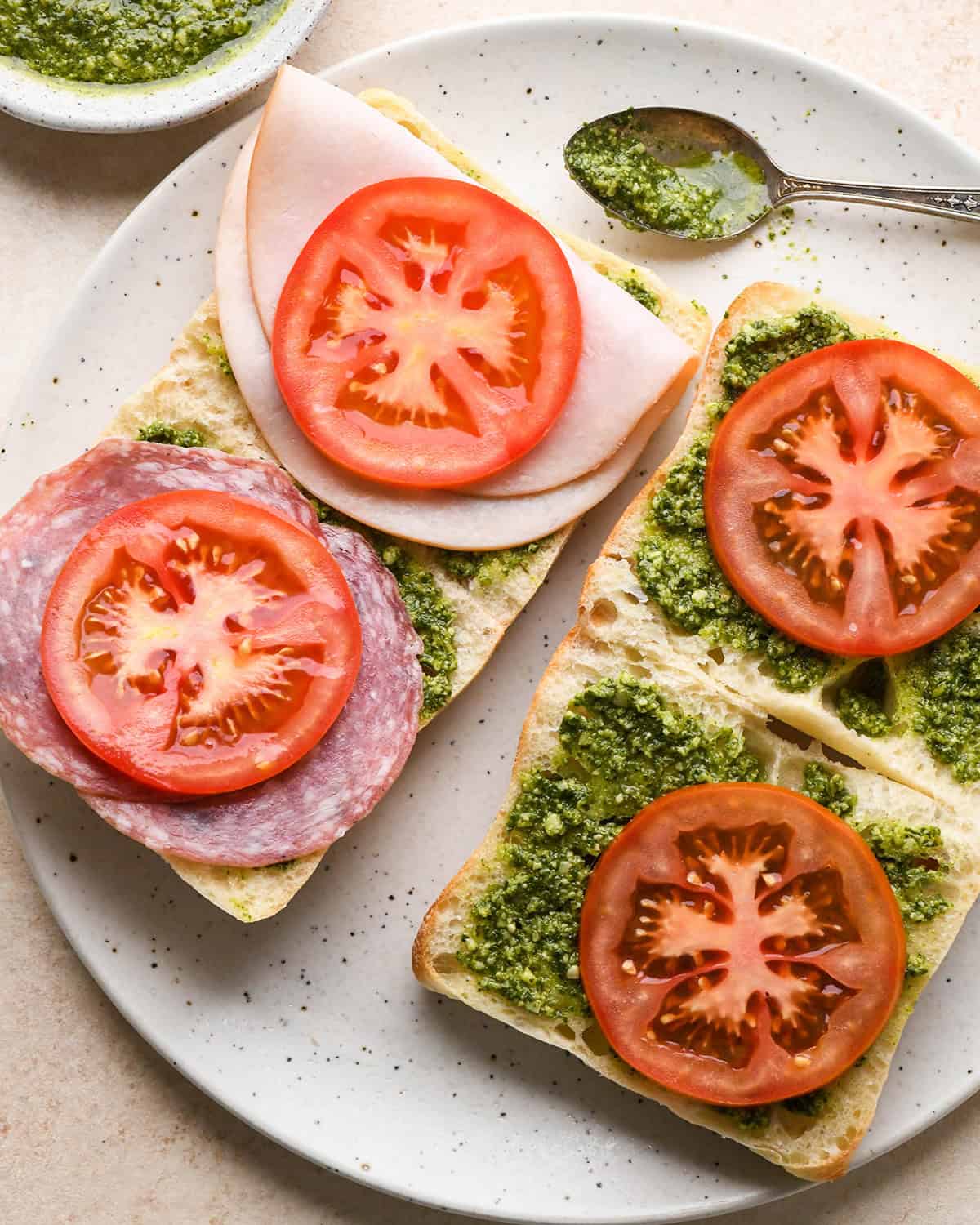 assembling a Caprese Sandwich - adding tomatoes