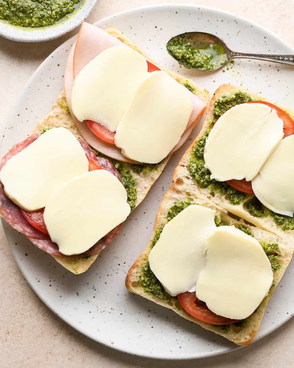 assembling a Caprese Sandwich - adding mozzarella cheese