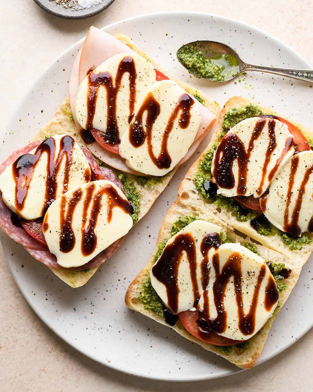 assembling Caprese Sandwiches - adding balsamic glaze and salt and pepper