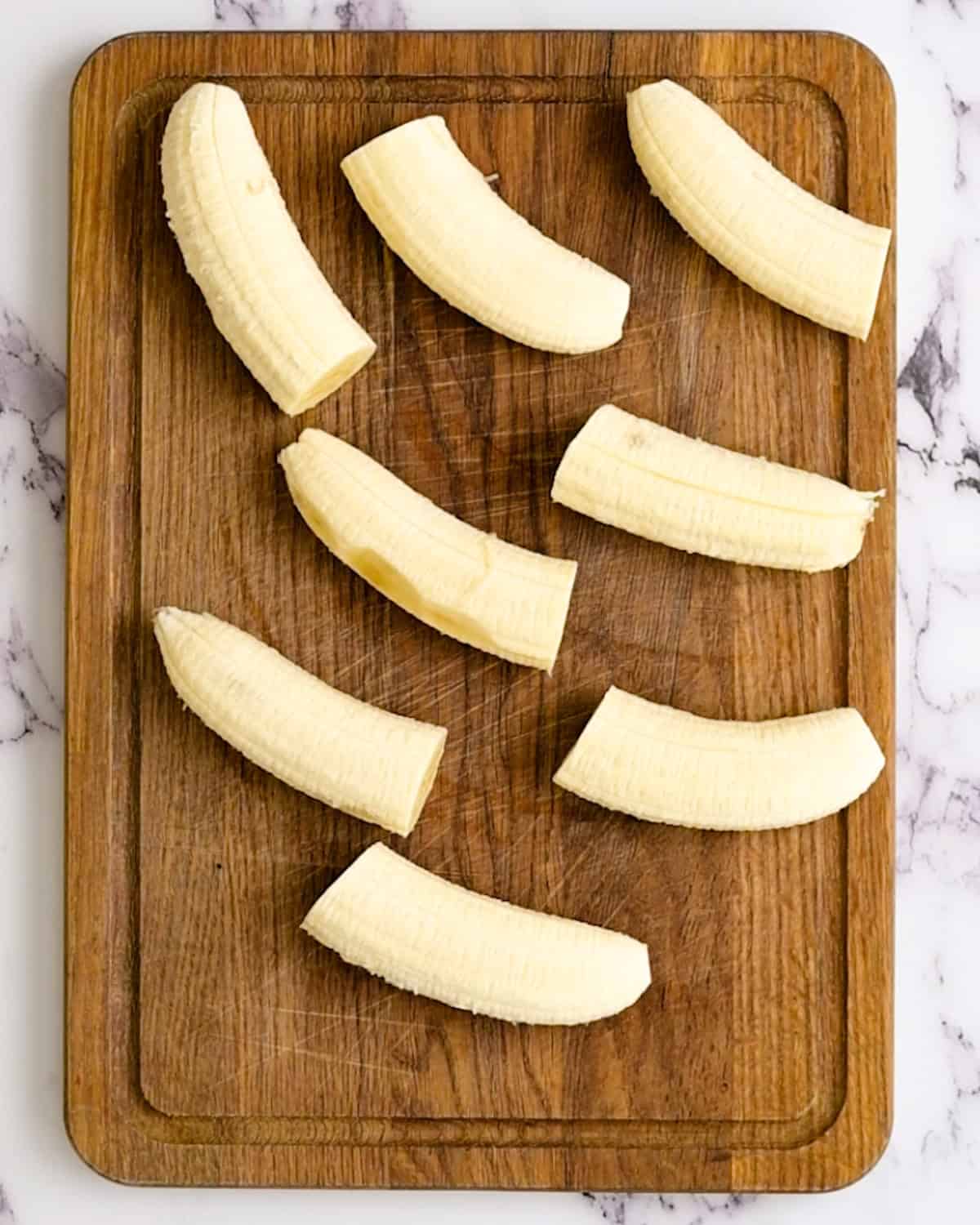 bananas cut in half on a cutting board