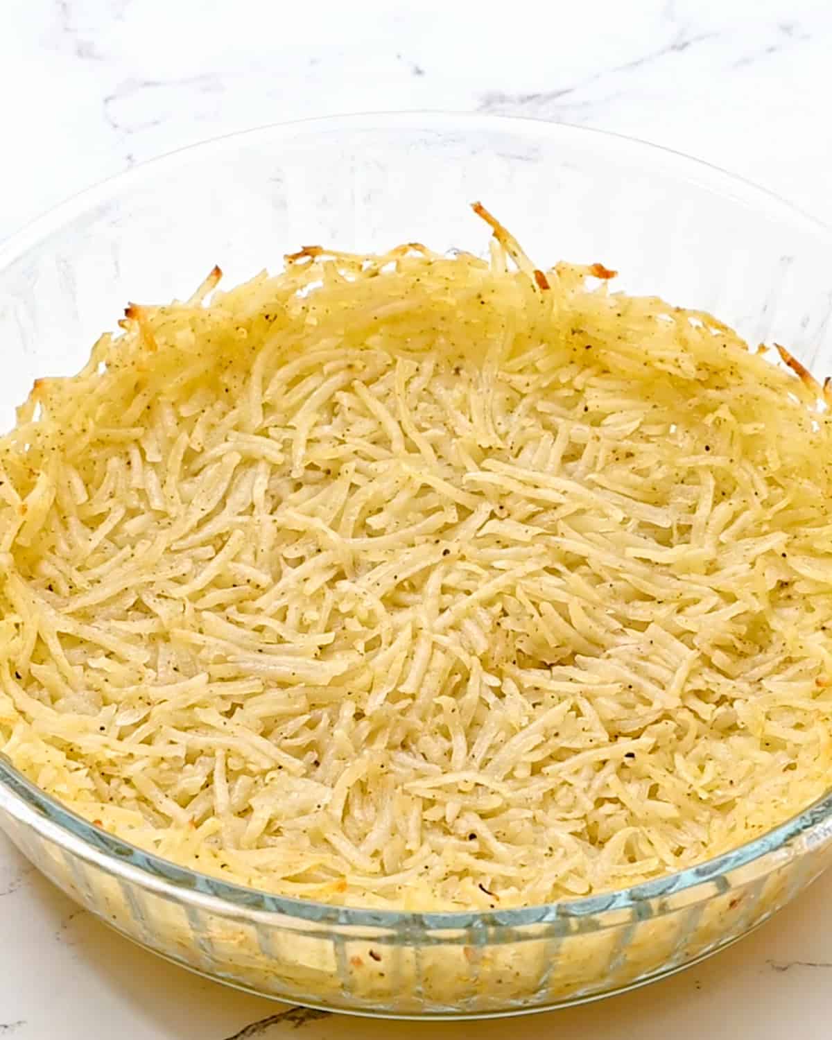 hash brown crust in a pie dish after baking