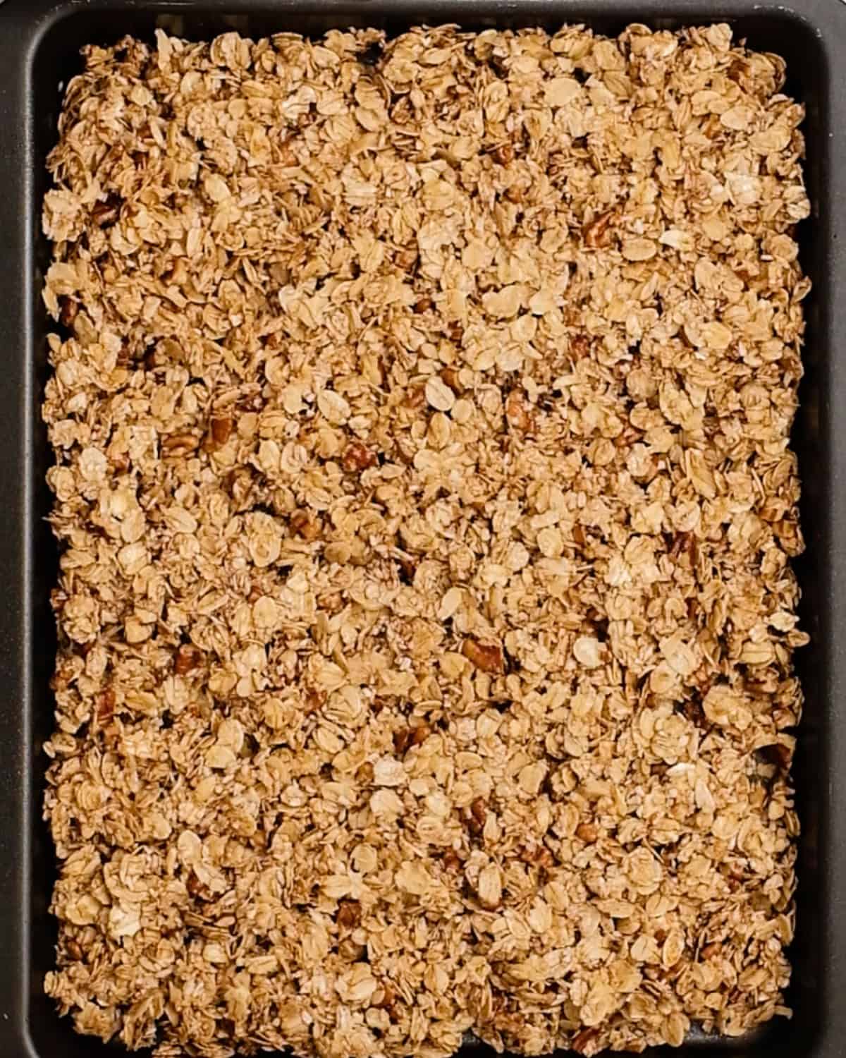 How to Make Homemade Granola - granola on a pan before baking