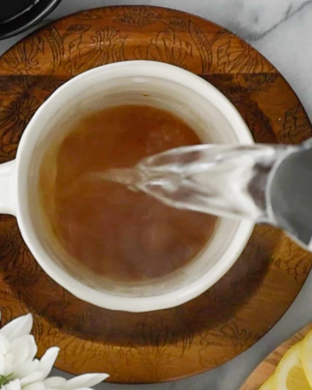How to Make Immune Boosting Tea pouring hot water into a mug