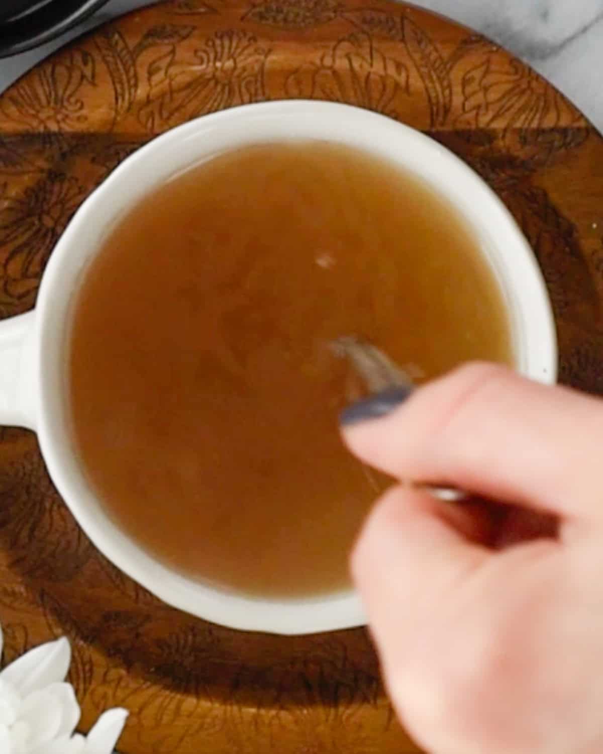 How to Make Immune Boosting Tea - stirring the tea with a spoon