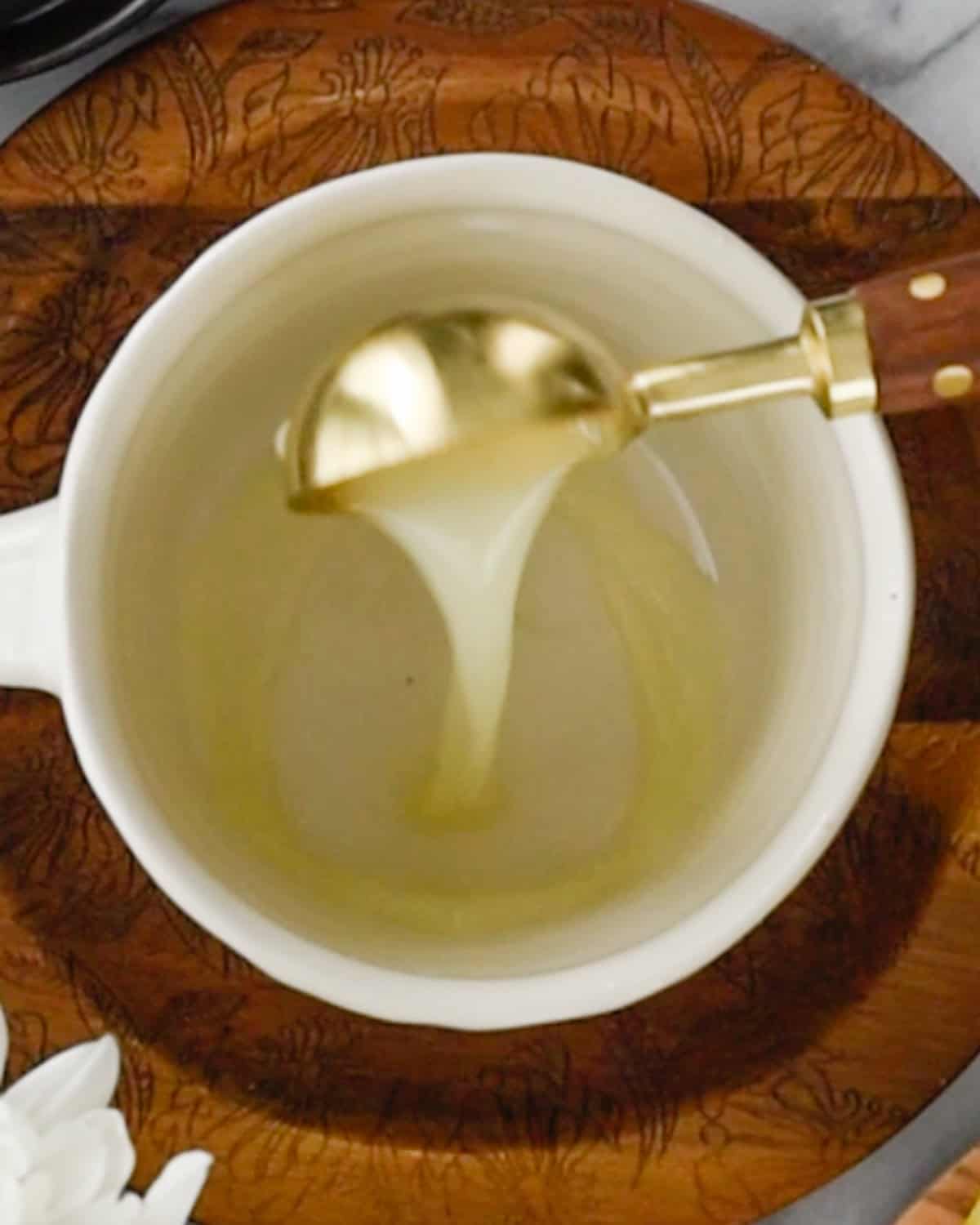 How to Make Immune Boosting Tea pouring lemon juice into a mug