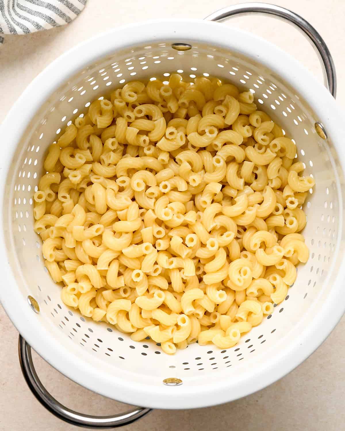 cooked macaroni noodles in a colander