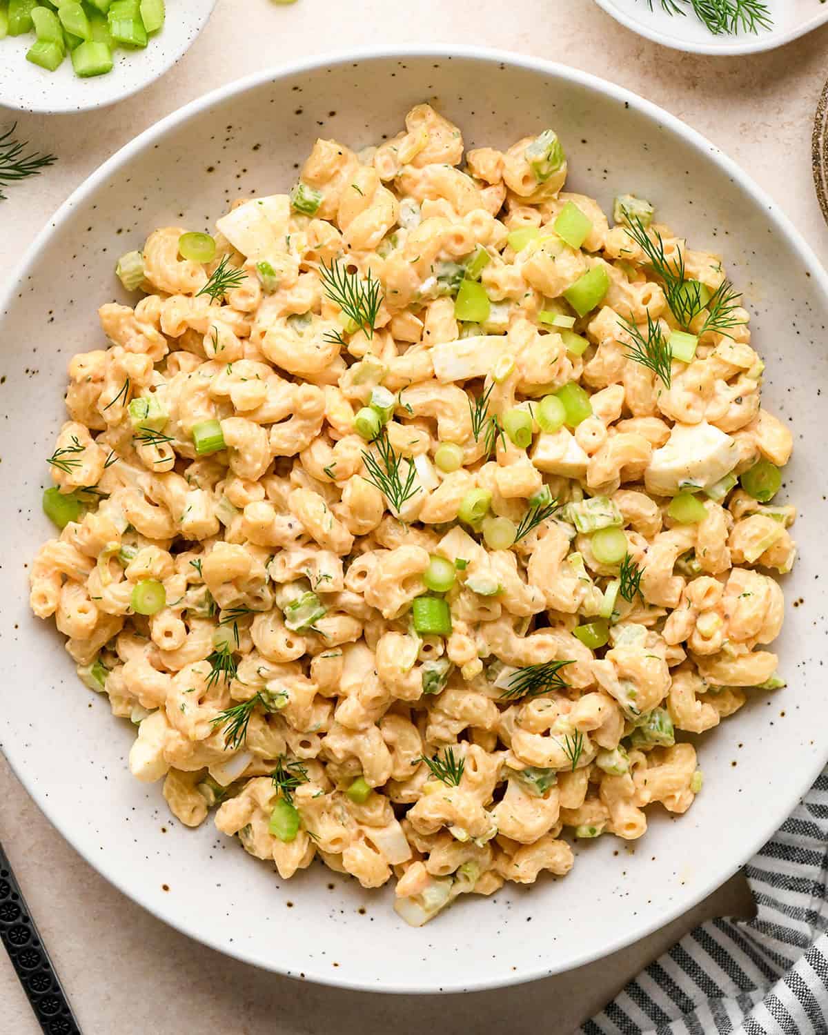 Macaroni Salad in a bowl garnished with dill