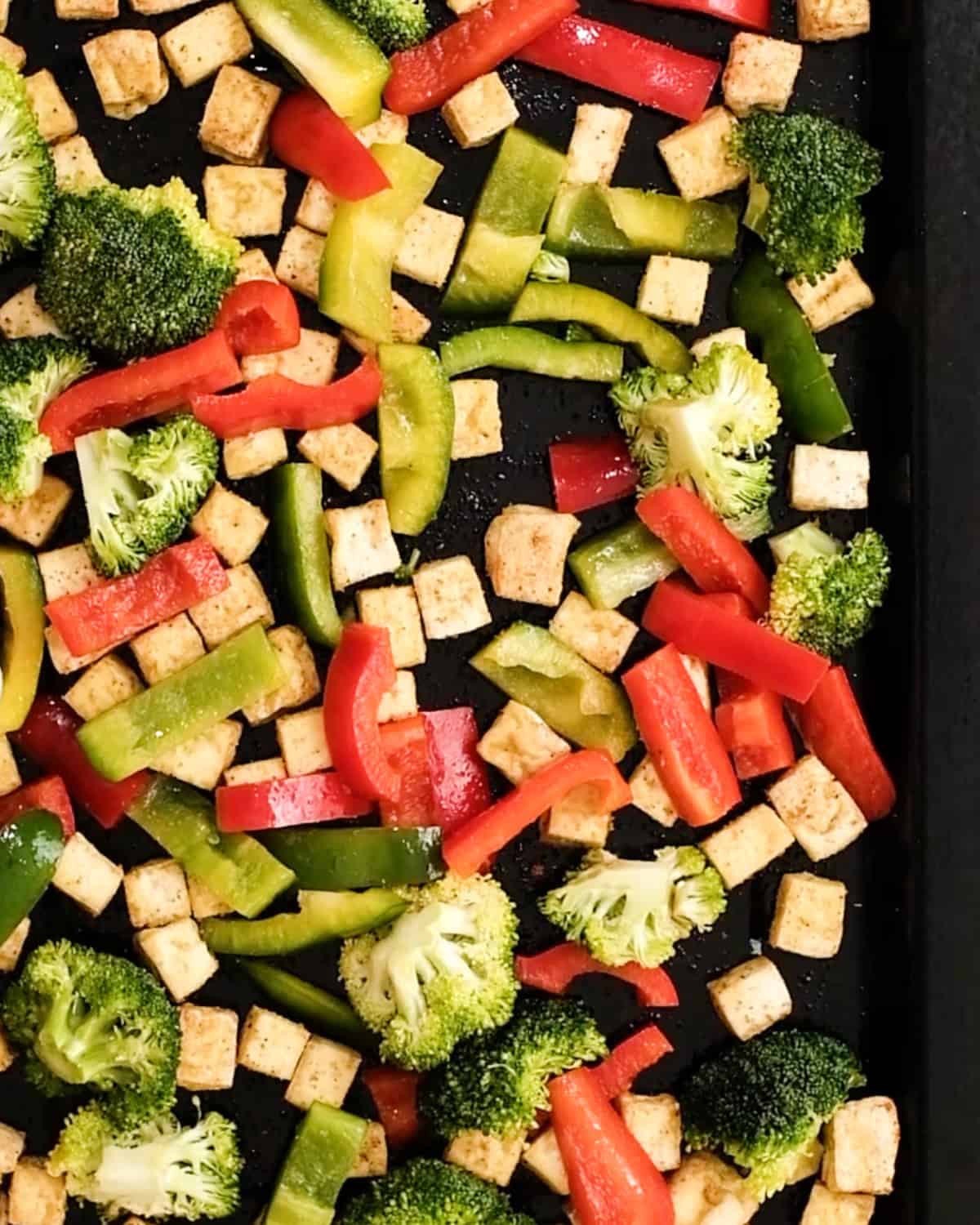 How to Make Baked Crispy Tofu adding vegetables to partially baked tofu