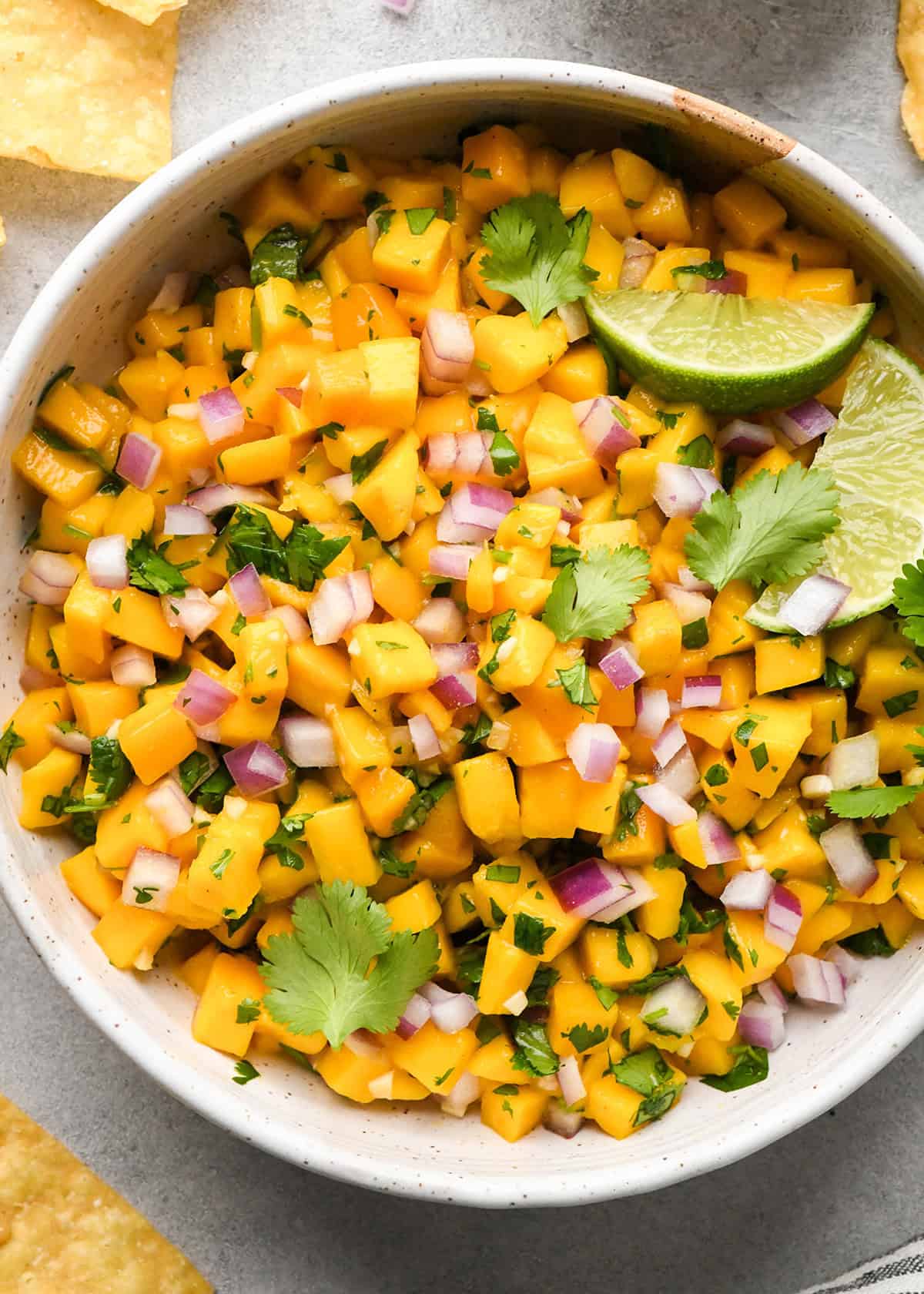 Mango Salsa in a bowl garnished with cilantro and lime