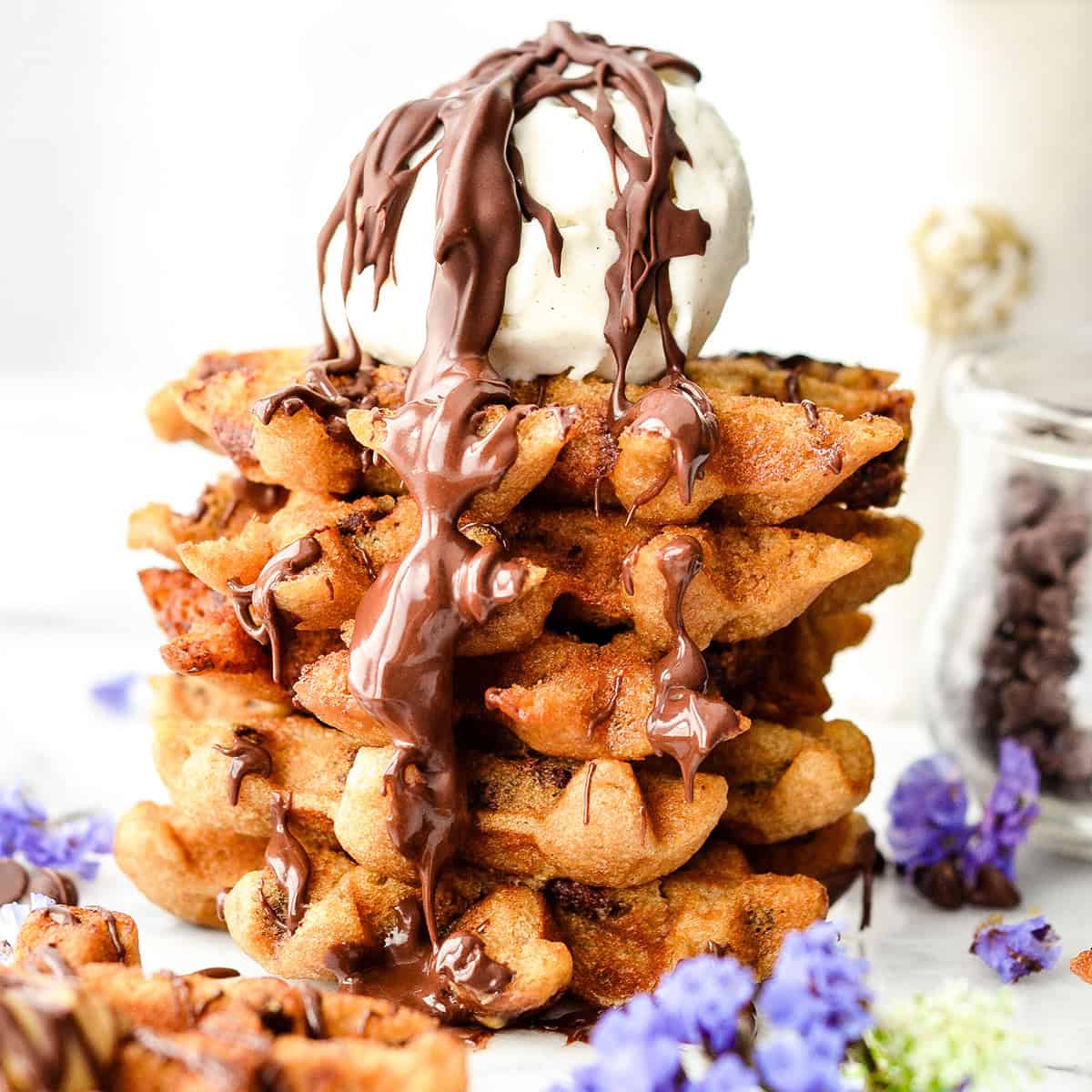 a stack of 5 Peanut Butter Waffle Cookies with a scoop of vanilla ice cream and melted chocolate