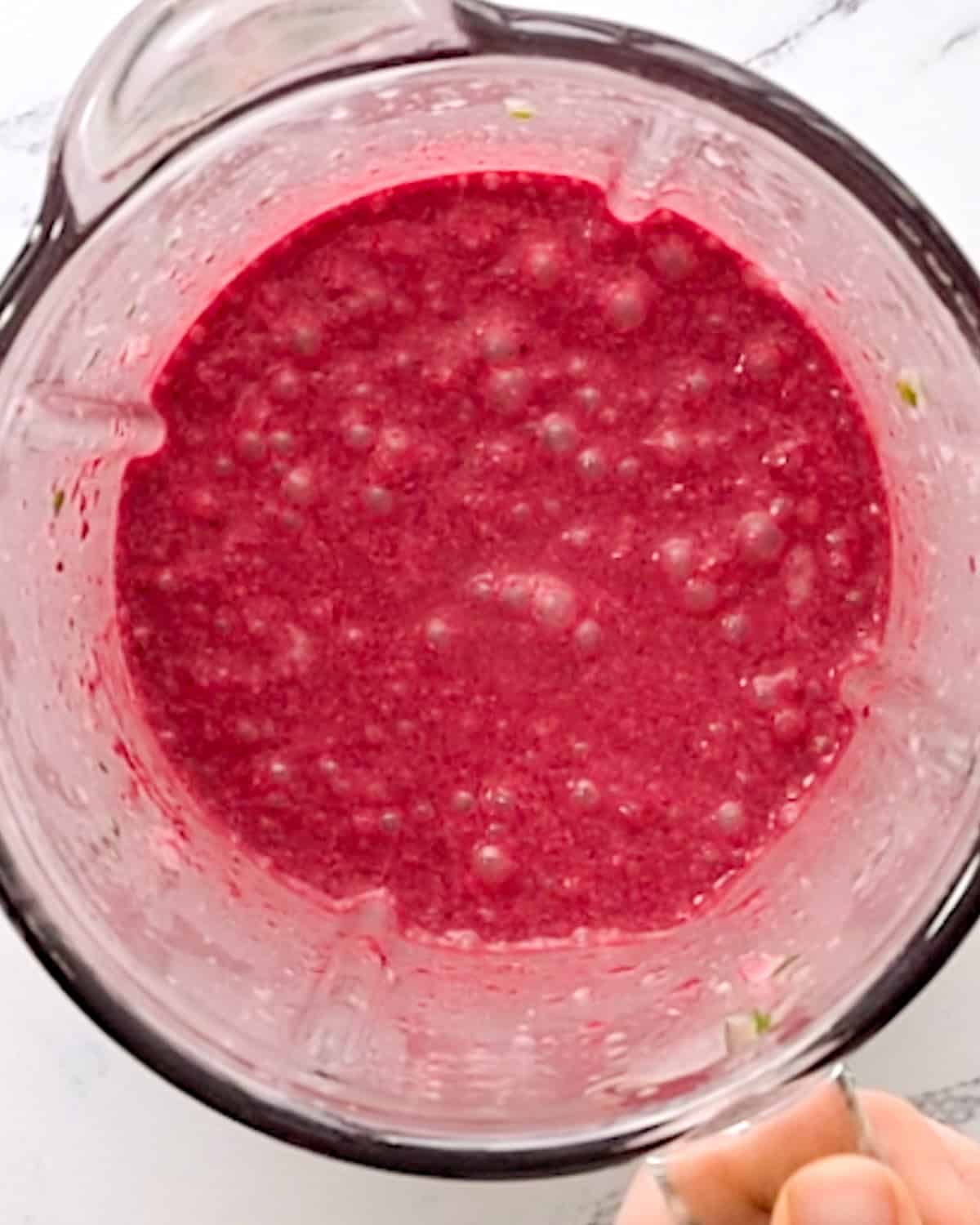 blended pomegranate smoothie in a blending container