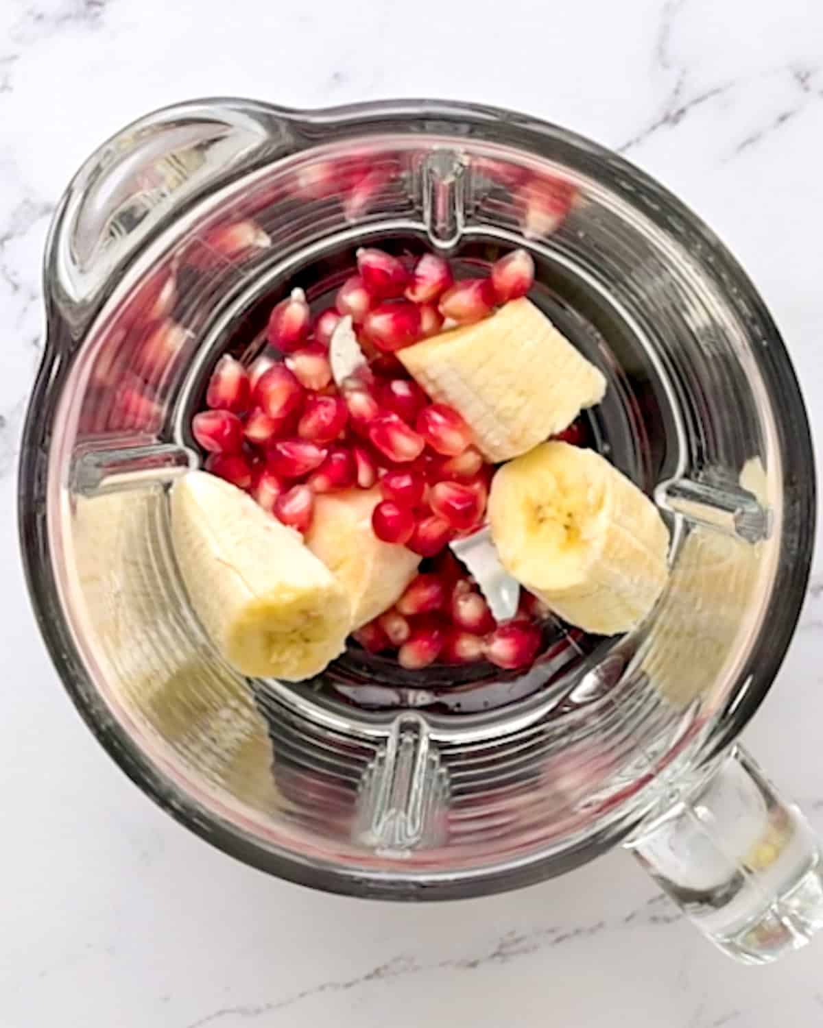 How to Make a Pomegranate Smoothie ingredients in the blender before blending