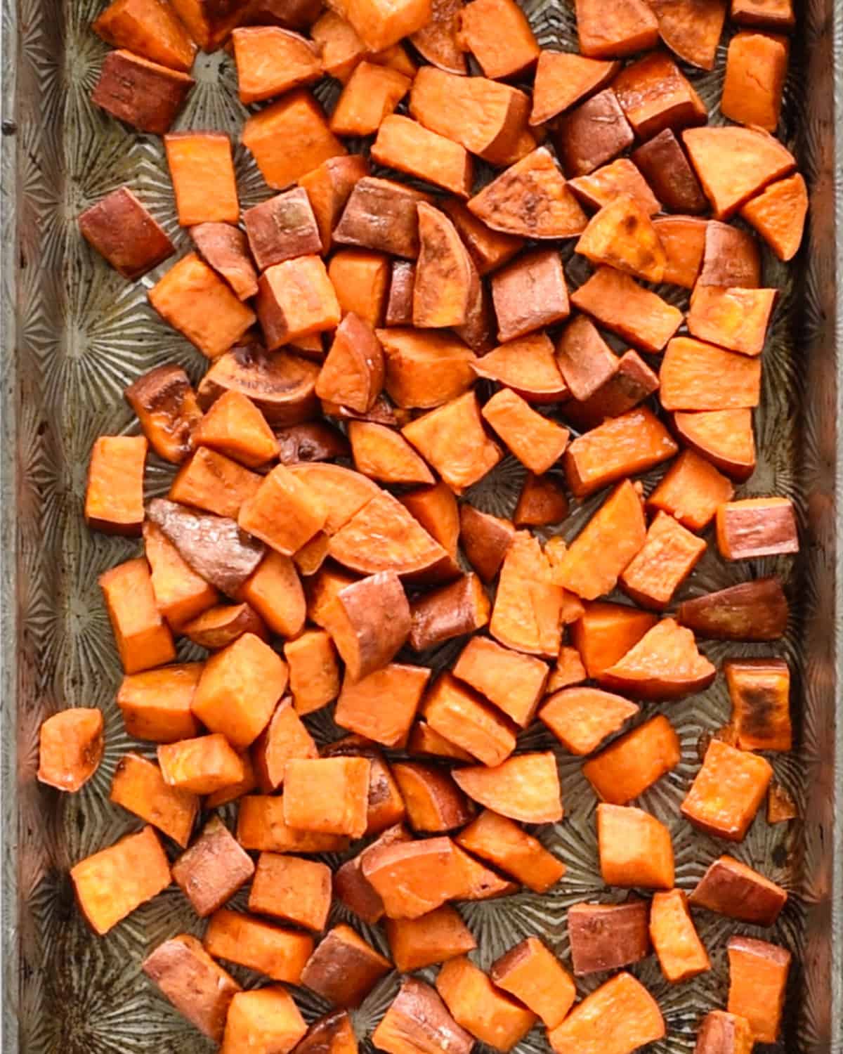 final cinnamon sweet potatoes on a baking sheet after roasting
