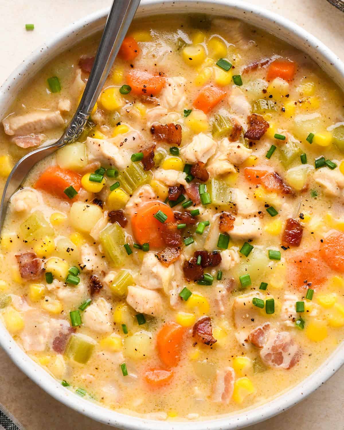 a bowl of Sweet Corn & Chicken Soup with a spoon