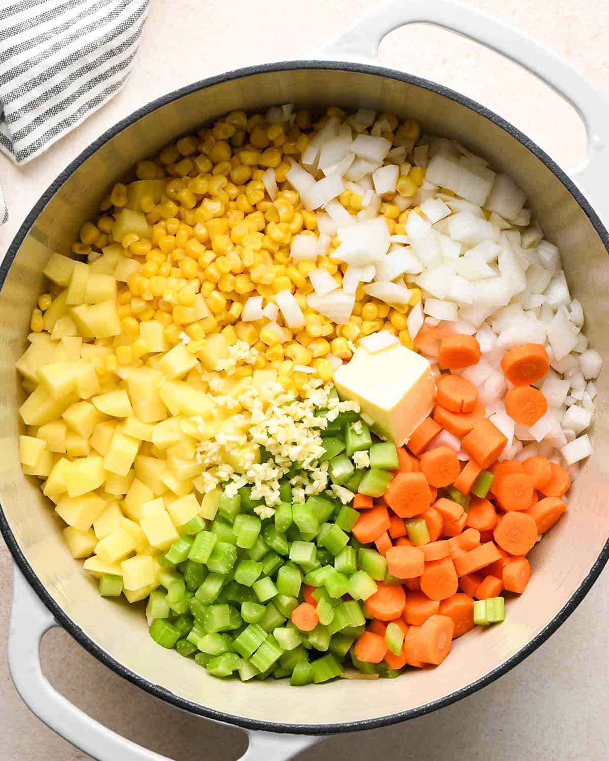 how to make Sweet Corn & Chicken Soup - adding vegetables and butter to cooked bacon & chicken in a pot