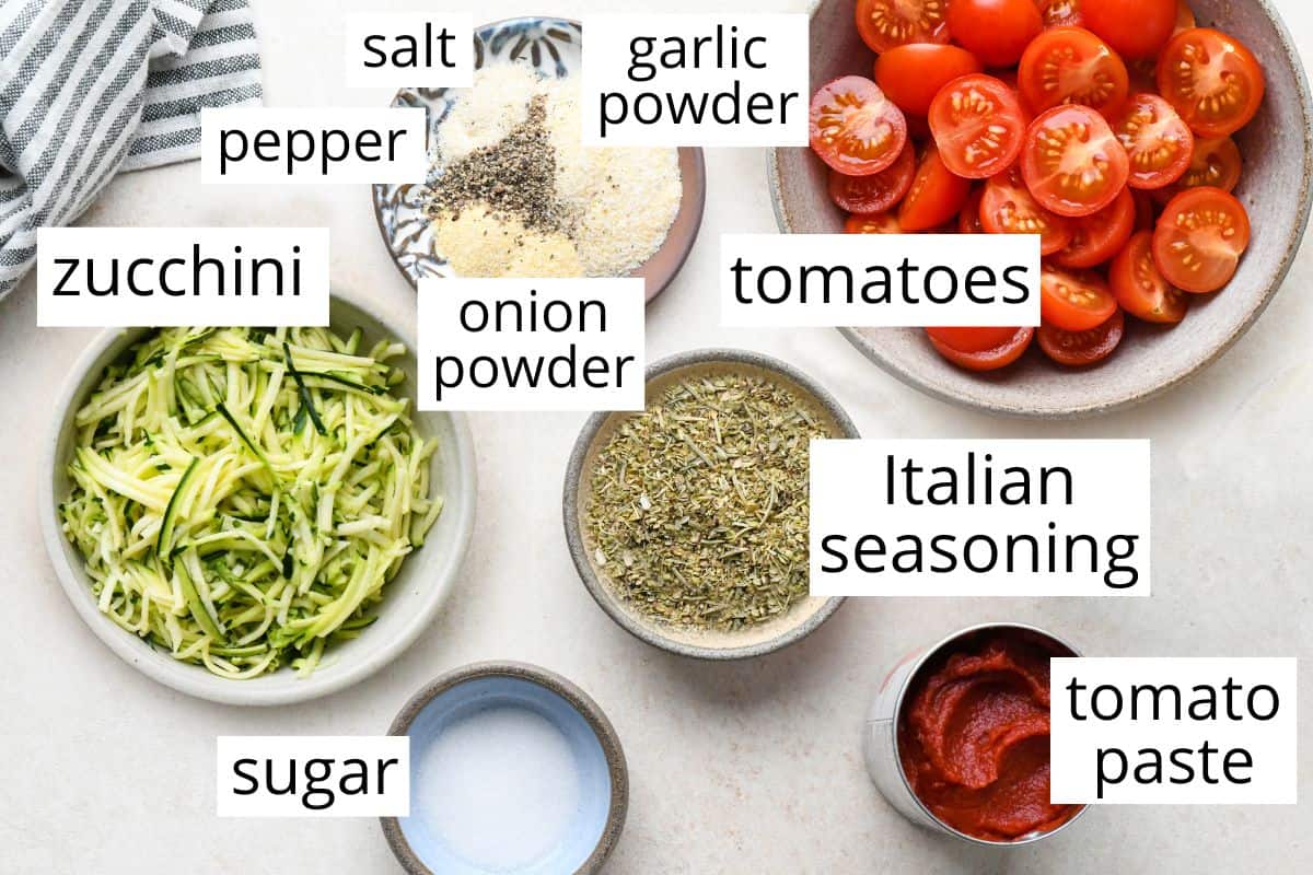 overhead photo of the labeled ingredients in this Tomato & Zucchini Pasta Sauce recipe