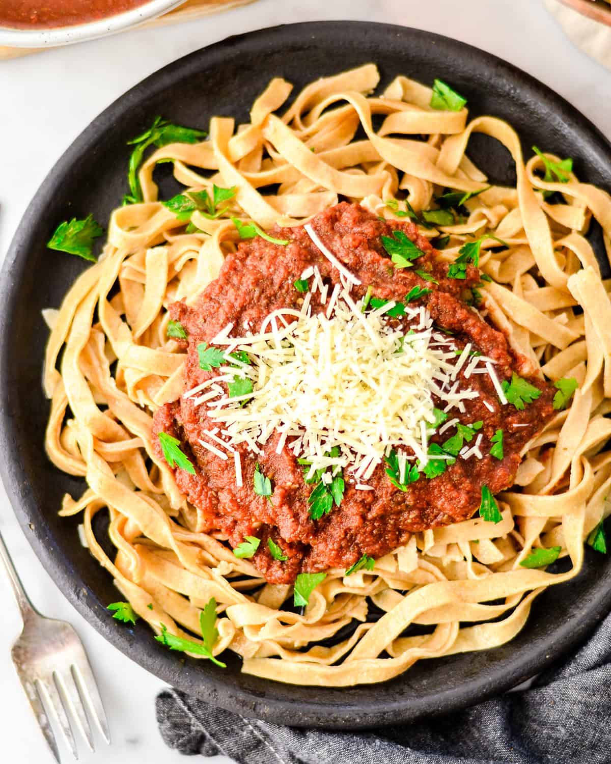 overhead photo of Tomato & Zucchini Pasta Sauce over noodles on a plate
