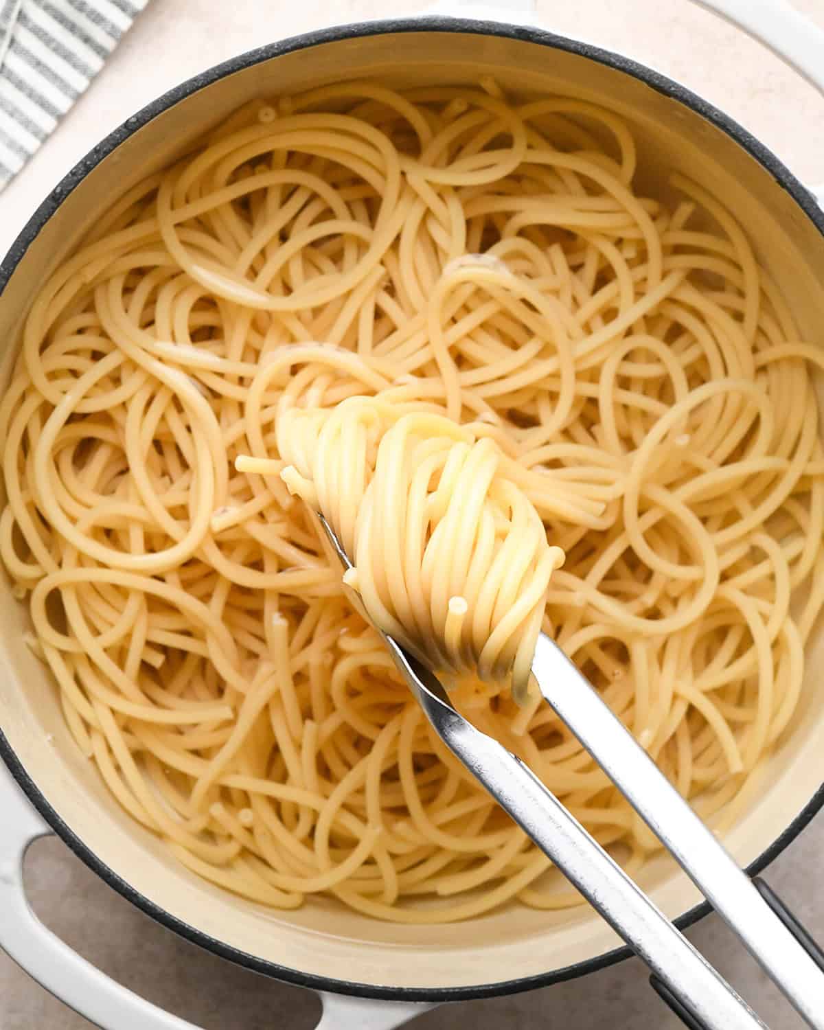 bucatini pasta cooking in water to make Cacio e Pepe Pasta