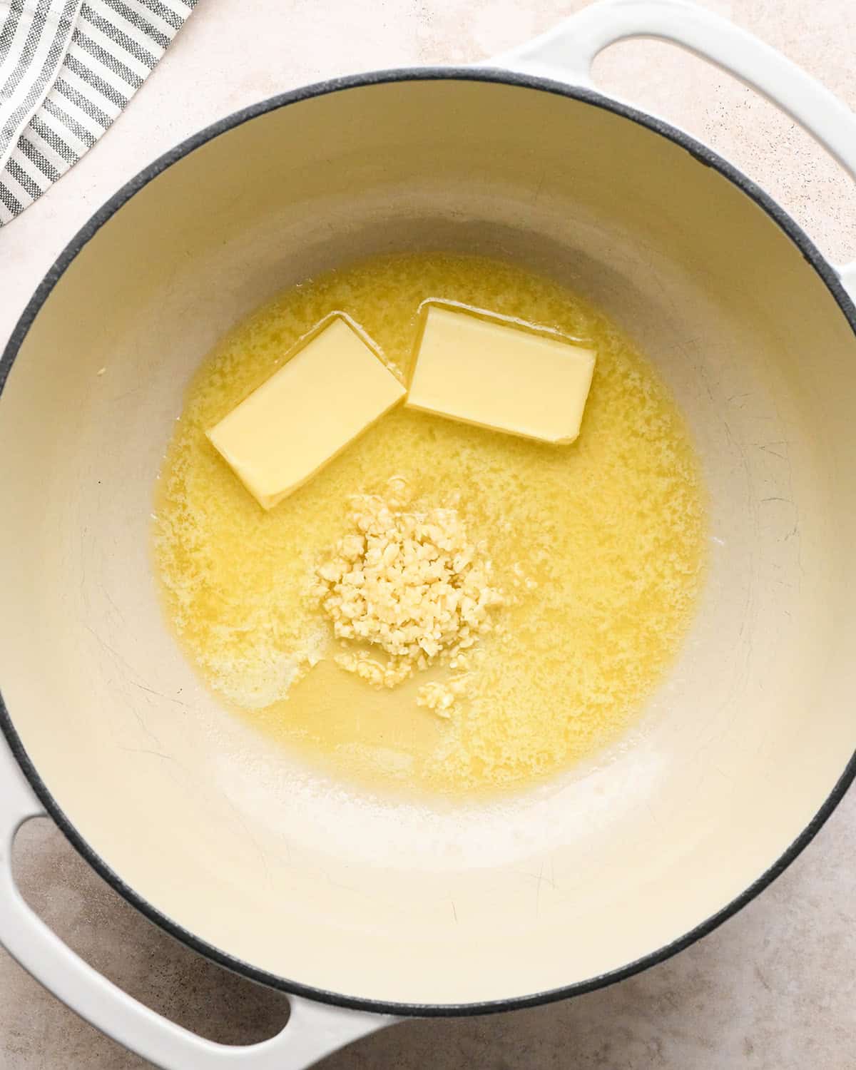 how to make Cacio e Pepe Pasta sauce - butter and garlic in a pot before melting