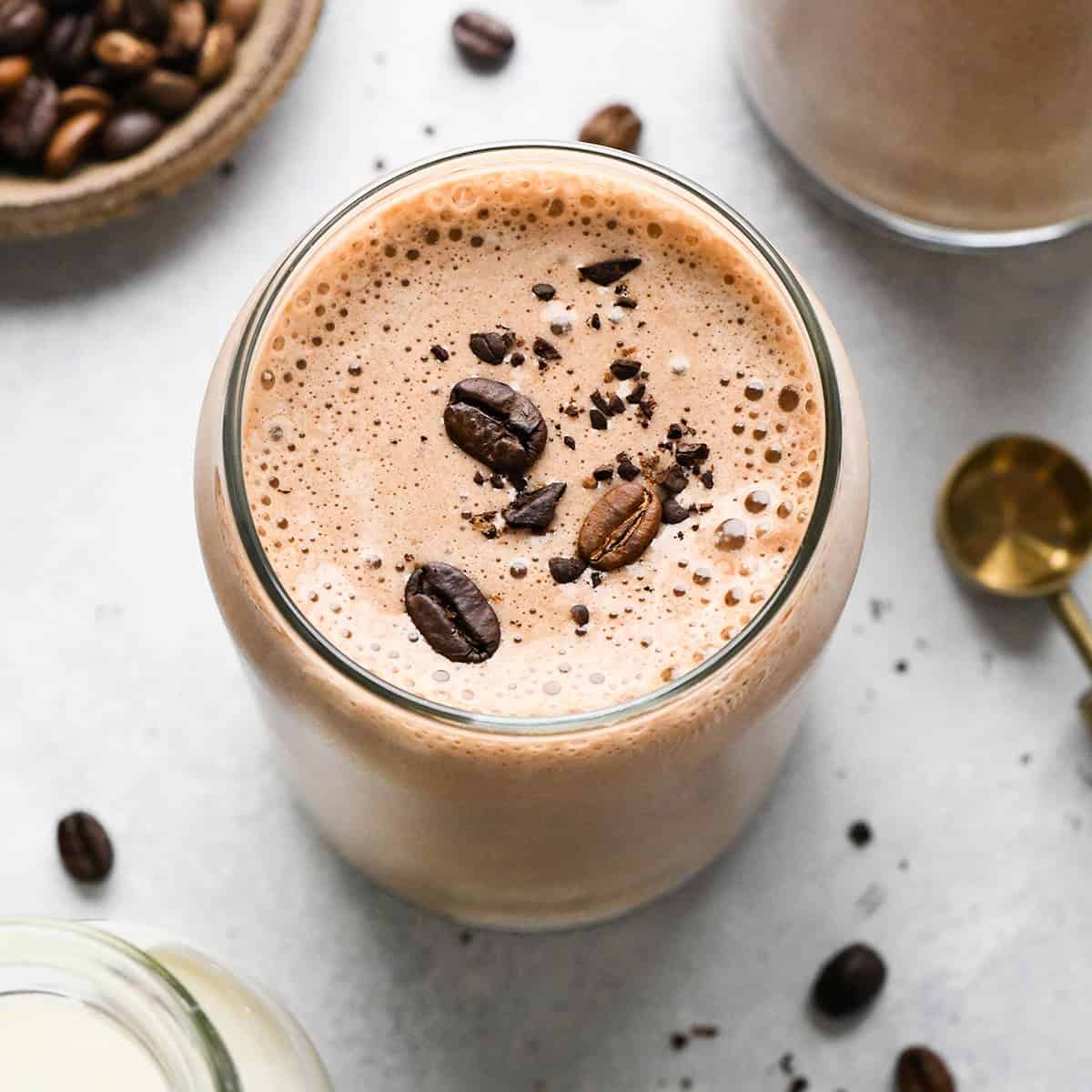 Coffee Smoothie in a glass topped with coffee beans