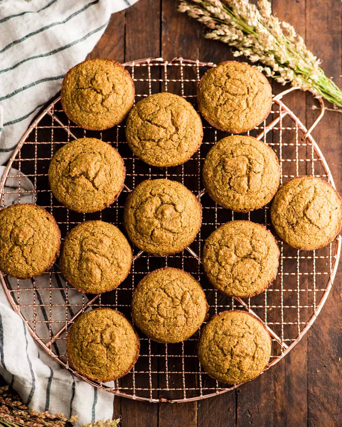 13 Carrot Zucchini Muffins on a wire cooling rack