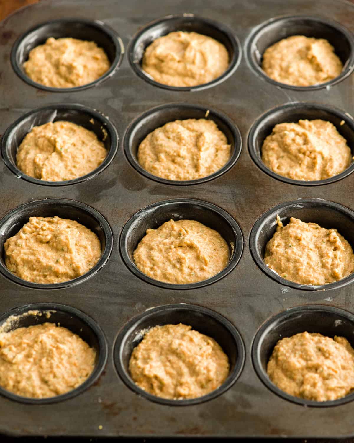 Carrot Zucchini Muffins in a muffin tin before baking