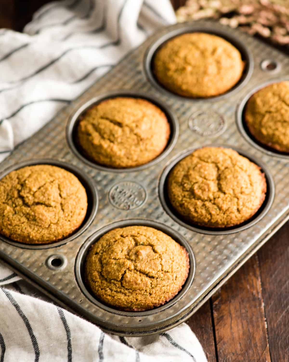 6 Carrot Zucchini Muffins  in a muffin tin after baking